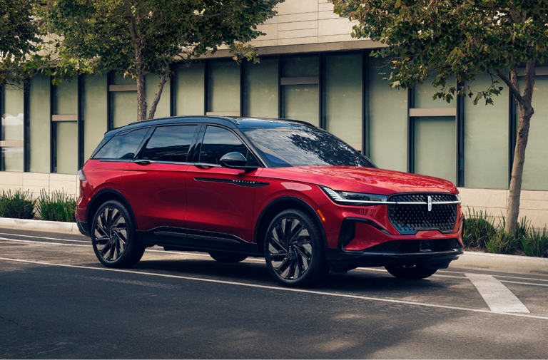 A 2024 Lincoln Nautilus® SUV drives along a city street