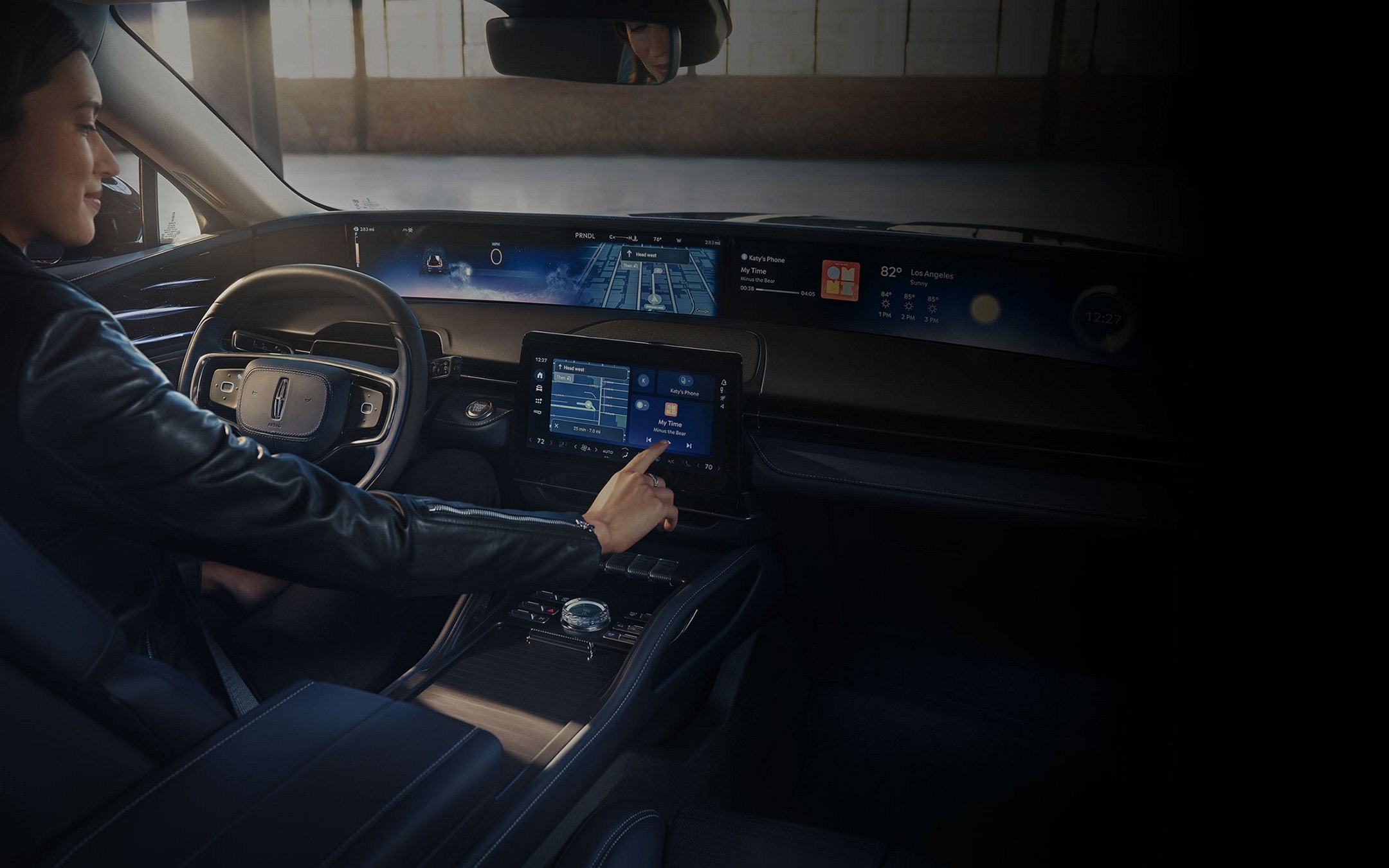 The driver of a 2025 Lincoln Nautilus® SUV interacts with the center-stack touchscreen